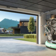 Rendering of double car garage with bicycles, kayak and other sporting goods hanging on wall. A luxury sedan is parked on the driveway.